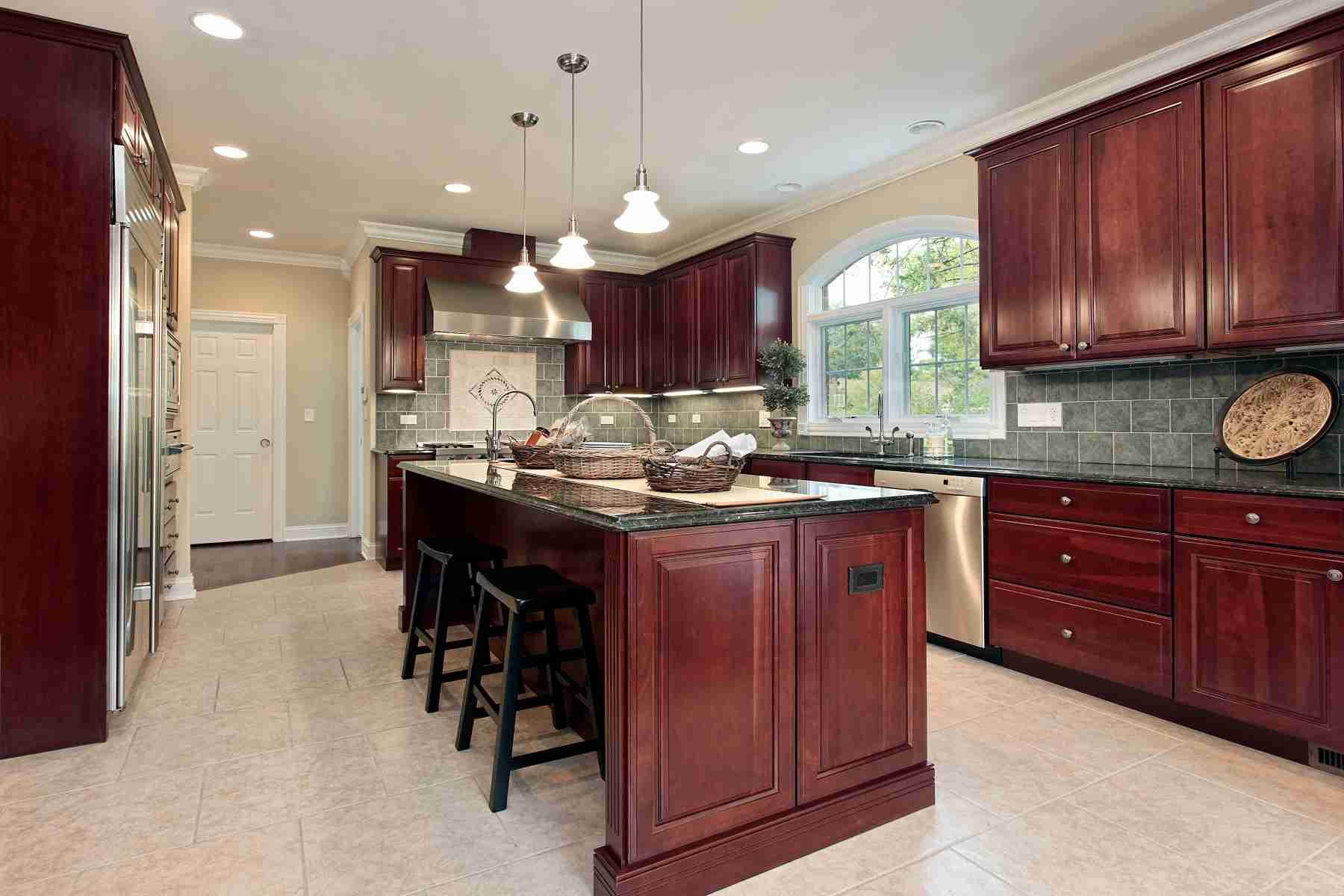 Cherry cabinets with gray backsplash