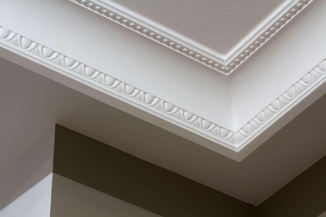 A wall with carved white crown molding
