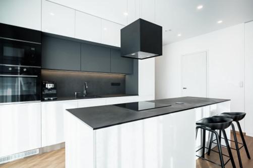 dark countertop with white cabinets