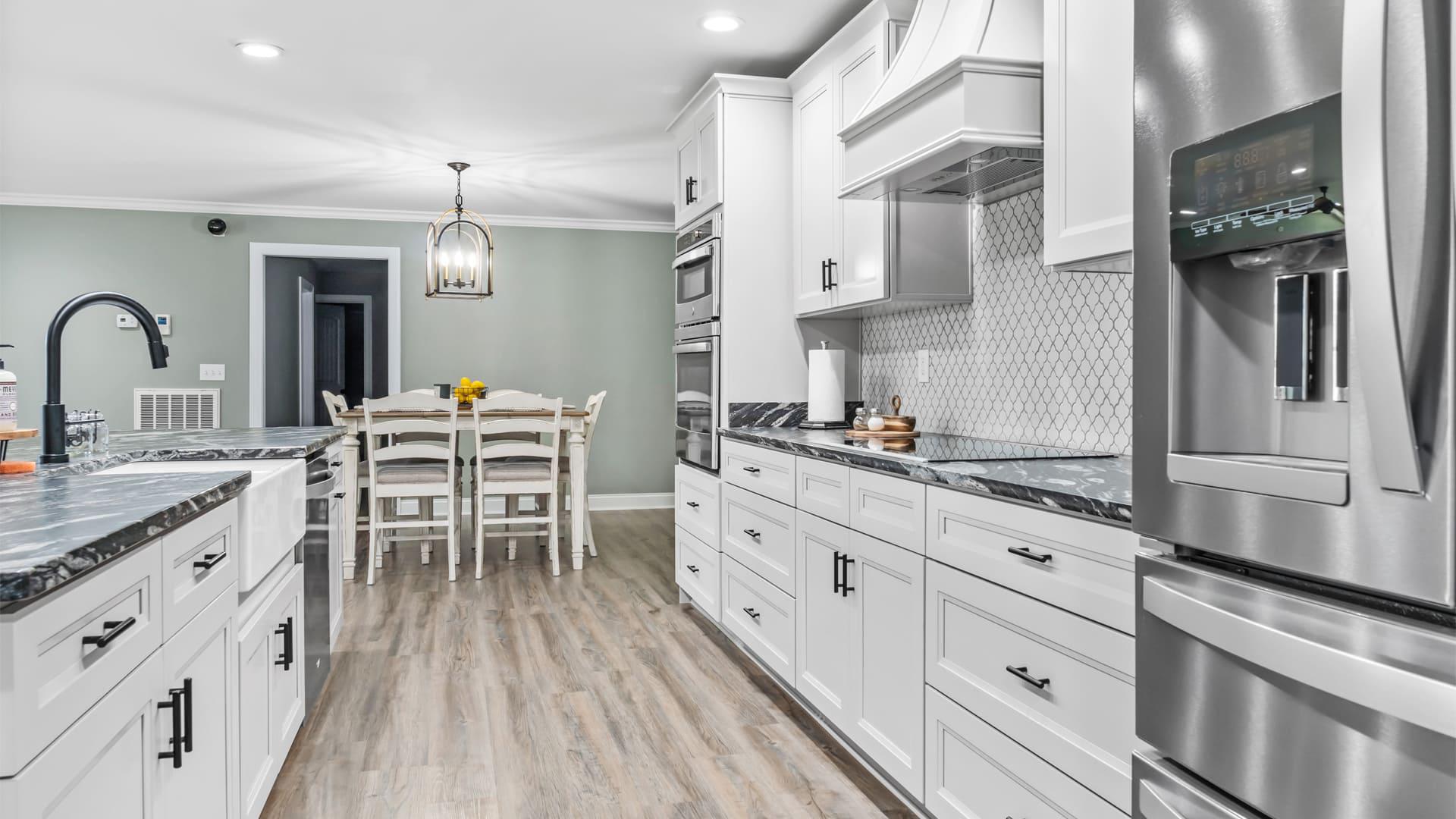Large kitchen with white cabinets