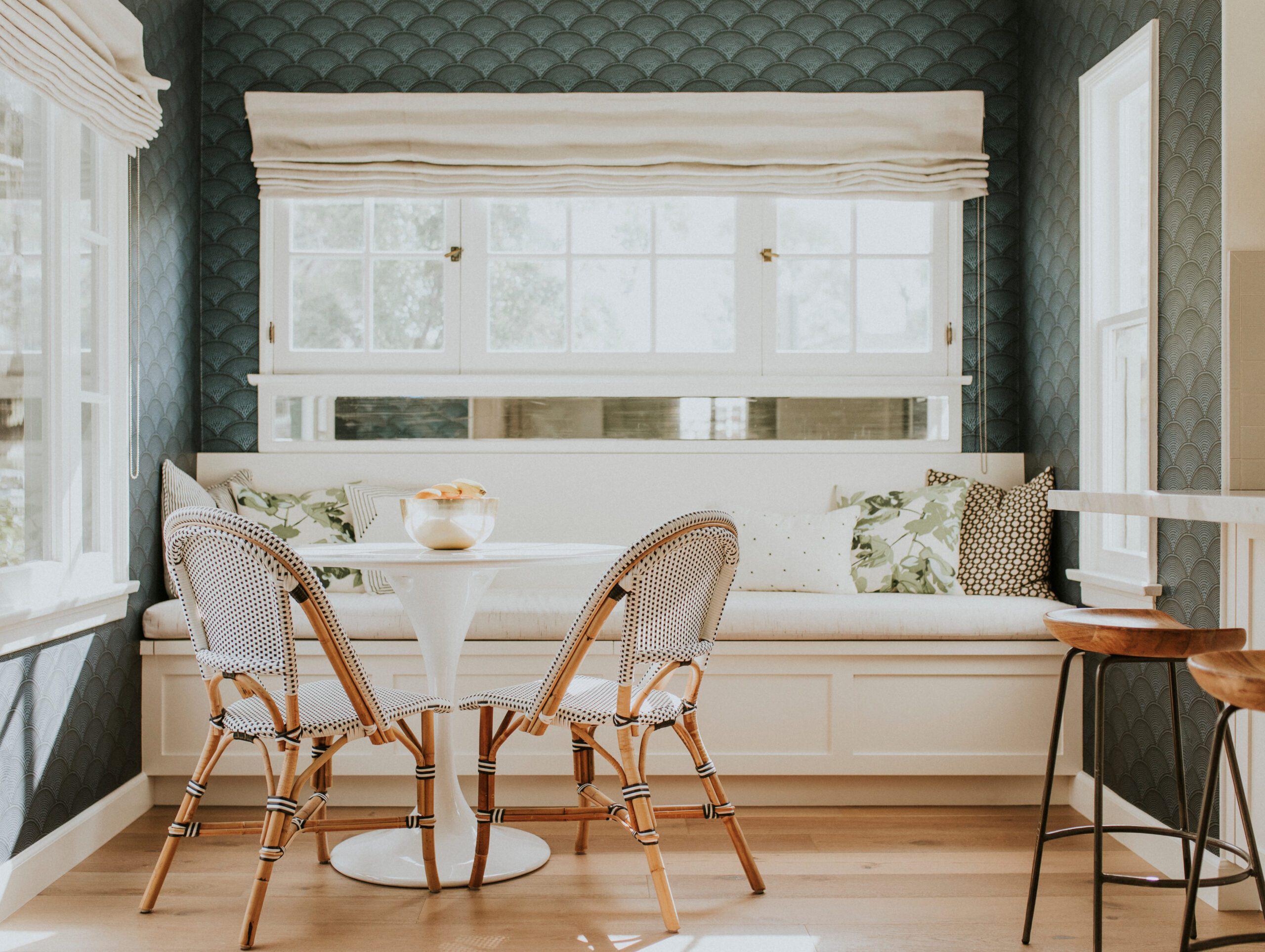Breakfast nook with large window and light curtains.