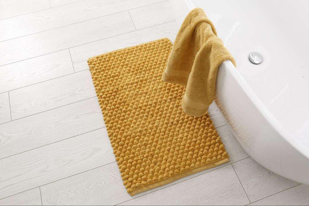 A yellow bath mat