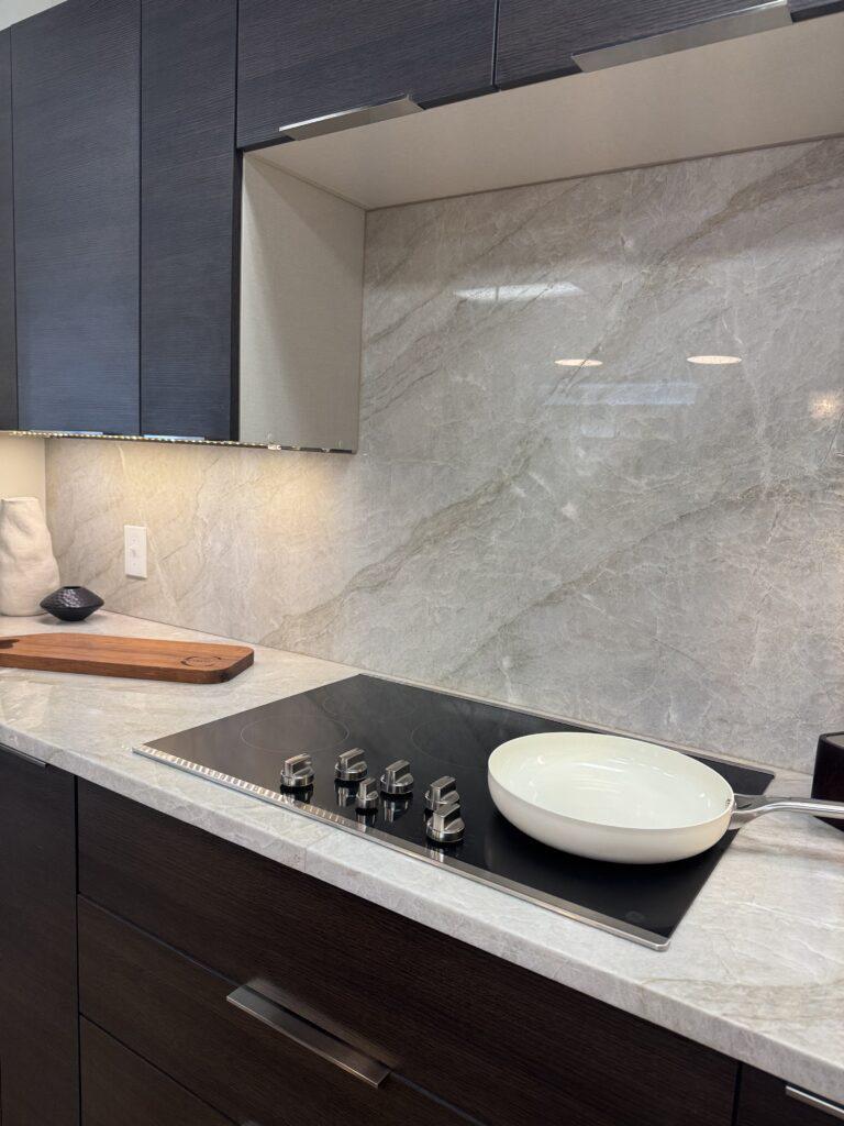 Sleek slab cabinets pair perfectly with a luxe marble backsplash for contrast.