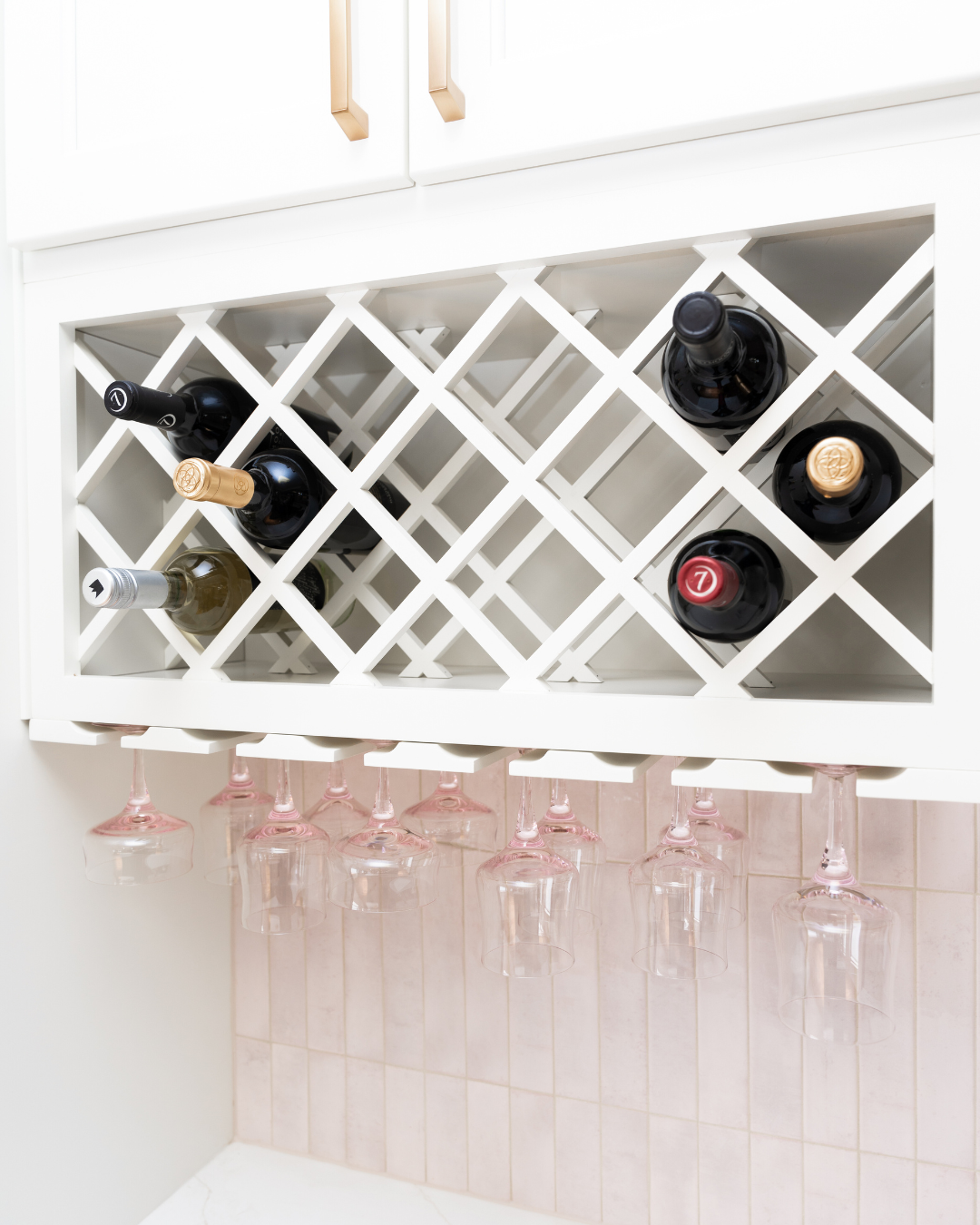 Kitchen organization featuring wine bottle and glassware storage.
