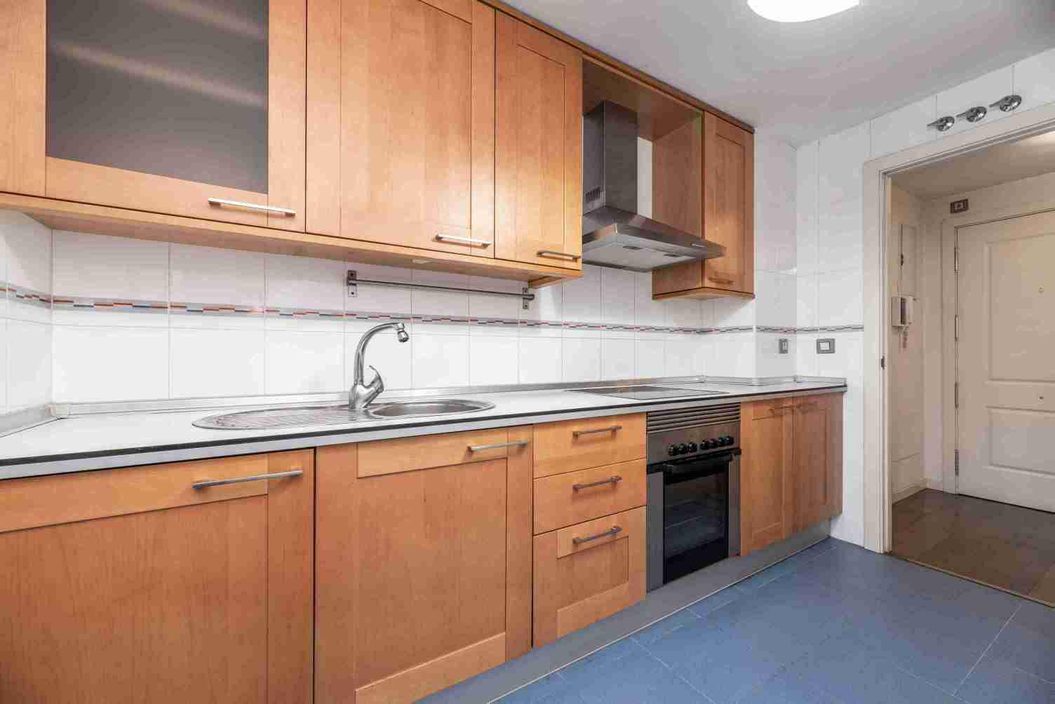 Kitchen with white wood countertops and cherry cabinets