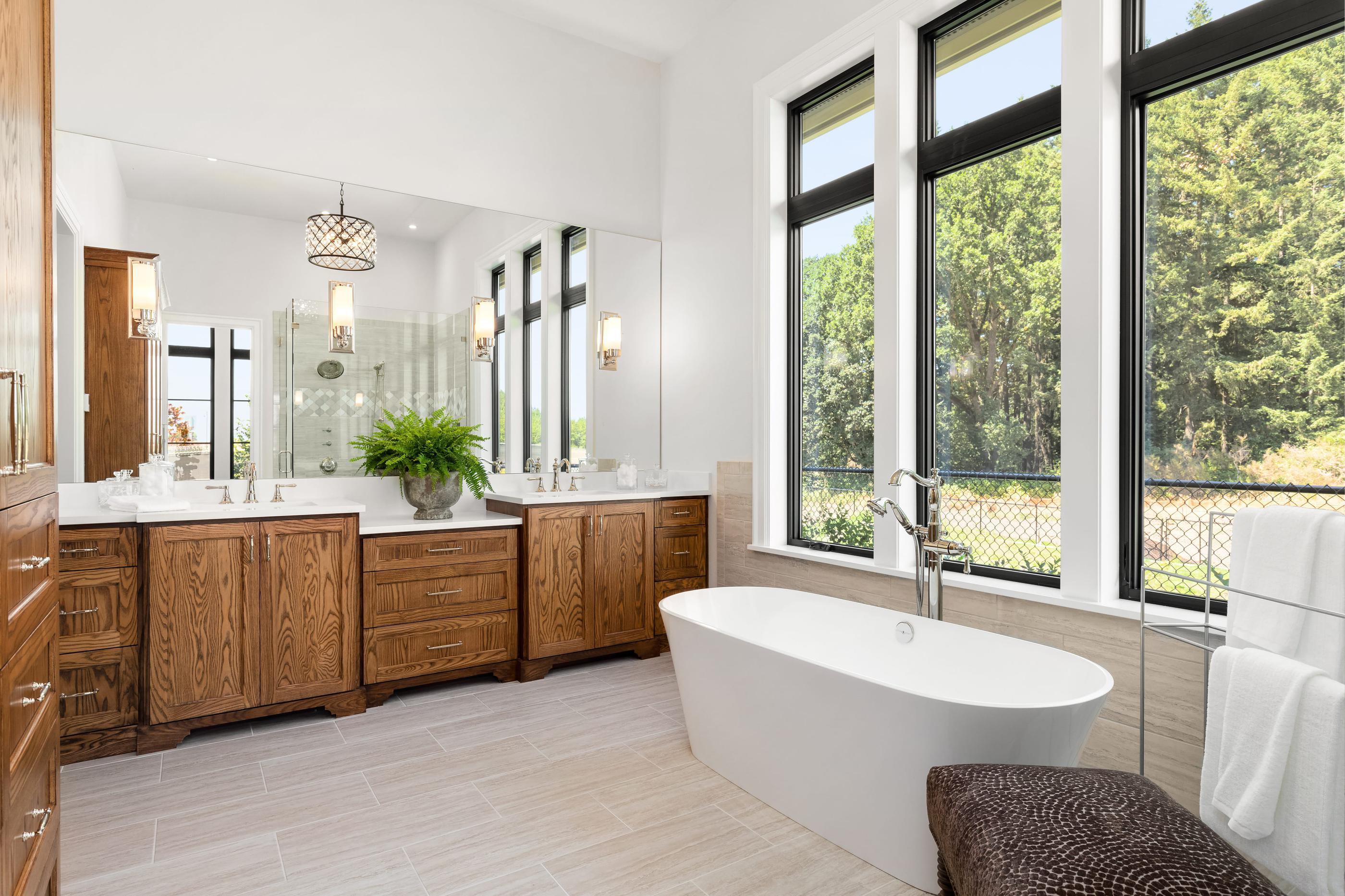 Luxury primary bathroom with soaking tub and custom double vanity.
