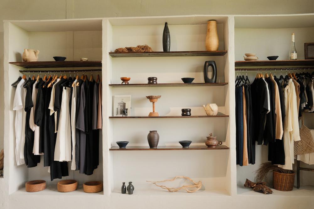 Walk in closet with display shelves and hanging racks