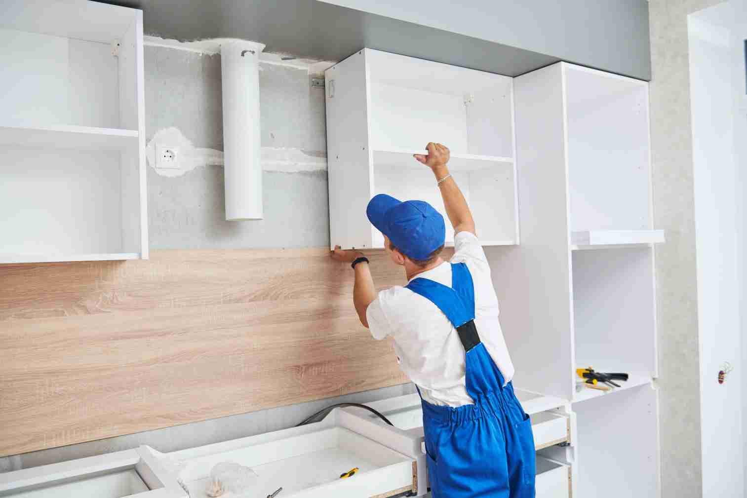 Professional installing kitchen cabinets