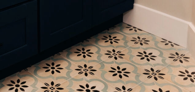 Close up of newly installed floor tiling featuring a repeating floral lantern pattern