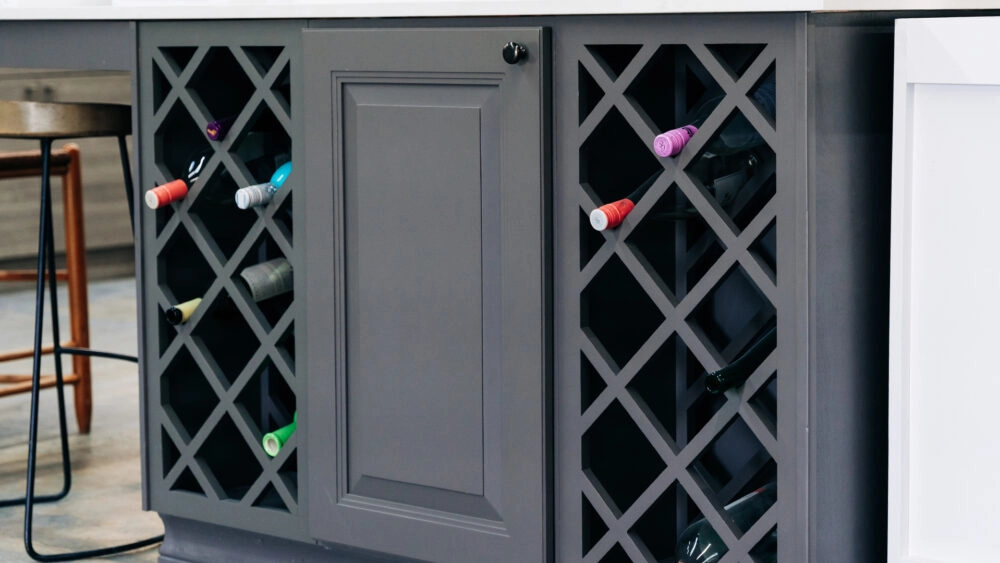 Charcoal gray cabinets with double wine rack storage