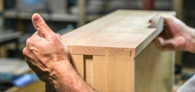 Boards of a cabinet drawer are put together by hand with slotted dado joints
