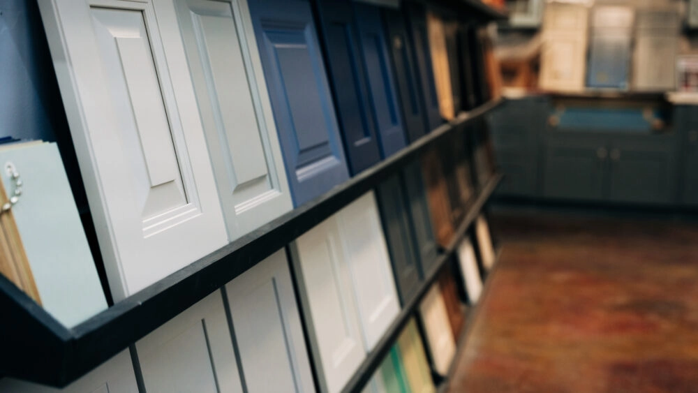 A wall of sample cabinet door styles in a variety of colors and finishes displayed in The Designery showroom