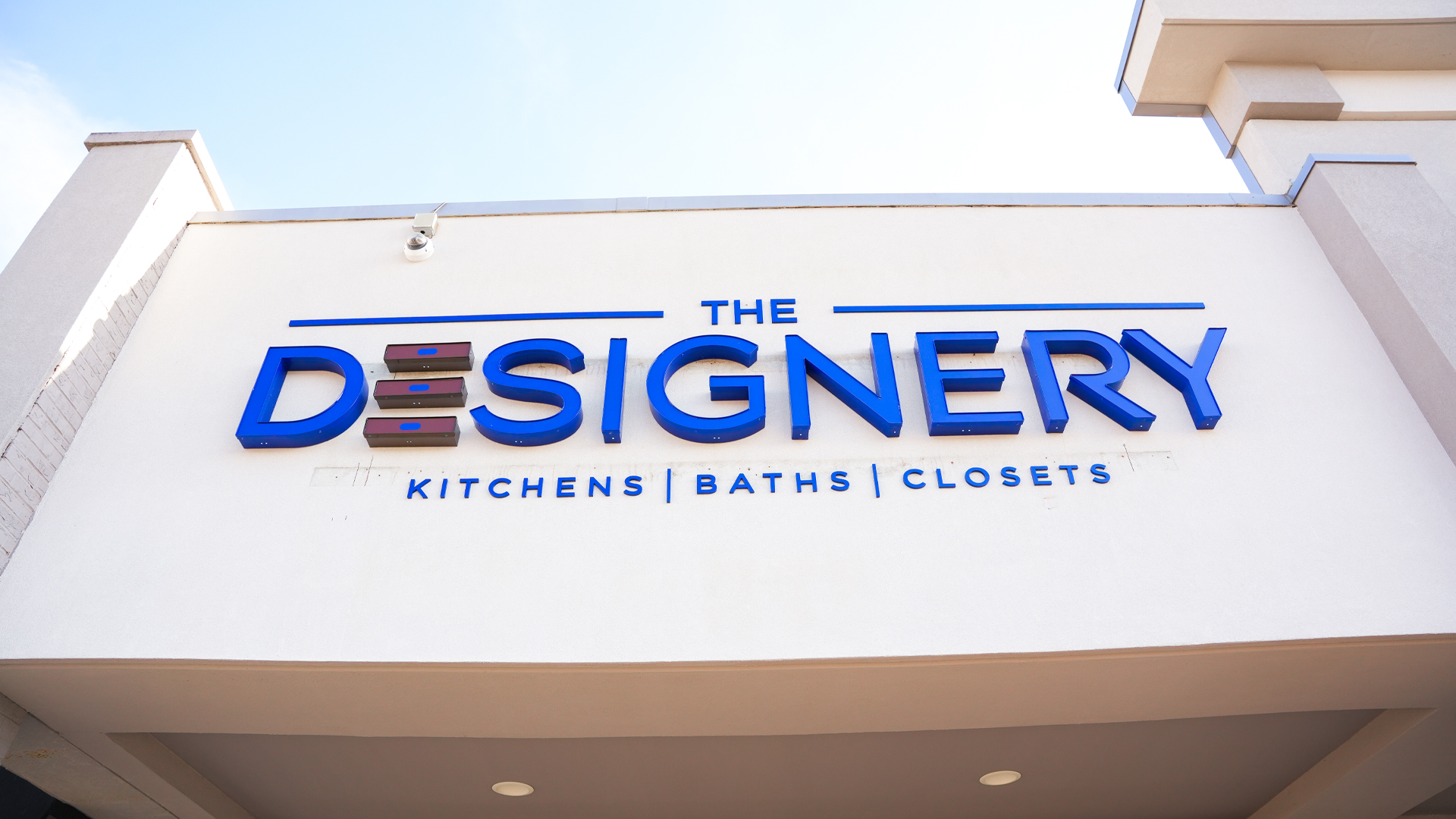 Close up of entry signage that reads 'The Designery Kitchens, Baths, Closets' at The Designery showroom