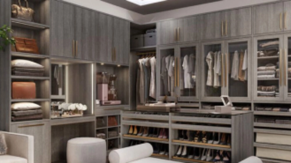 Luxurious, large walk-in closet with floor-to-ceiling closet cabinets for clothing and a storage cabinet island