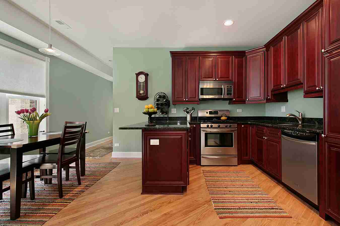 Cherry cabinets with contrasting green walls