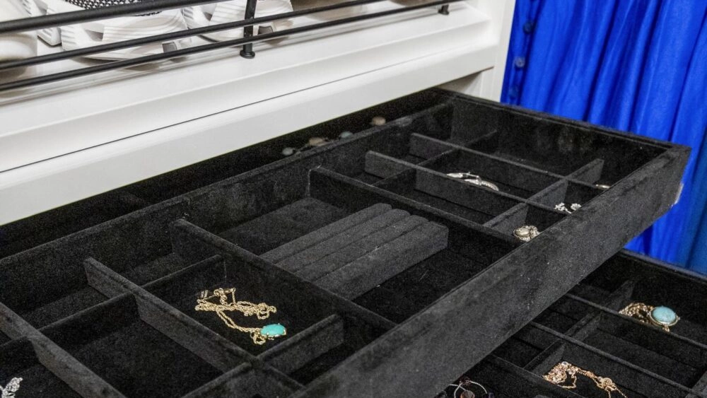 A black velvet jewelry organizer provides safe-keeping and organization for earrings and necklaces.