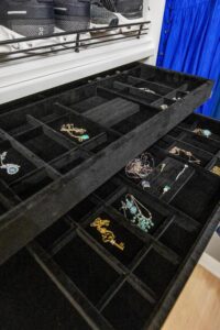 A black velvet jewelry organizer provides safe-keeping and organization for earrings and necklaces.