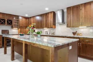 Beautiful and classic kitchen with a large island and industrial hood range.
