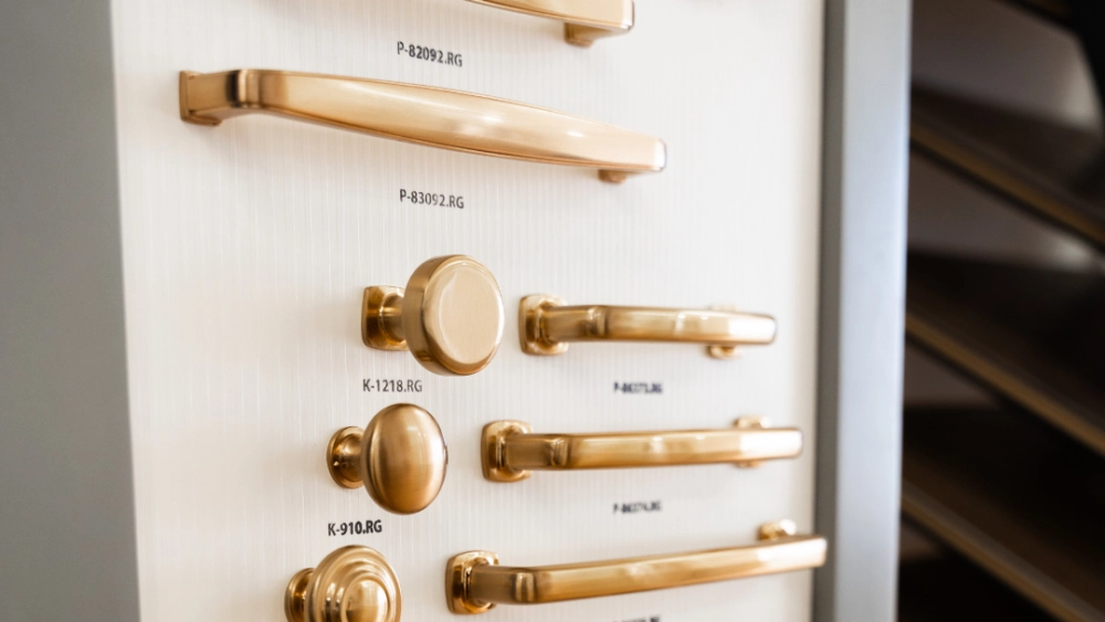 Beautiful, gold hardware options stacked on a board in a The Designery showroom.