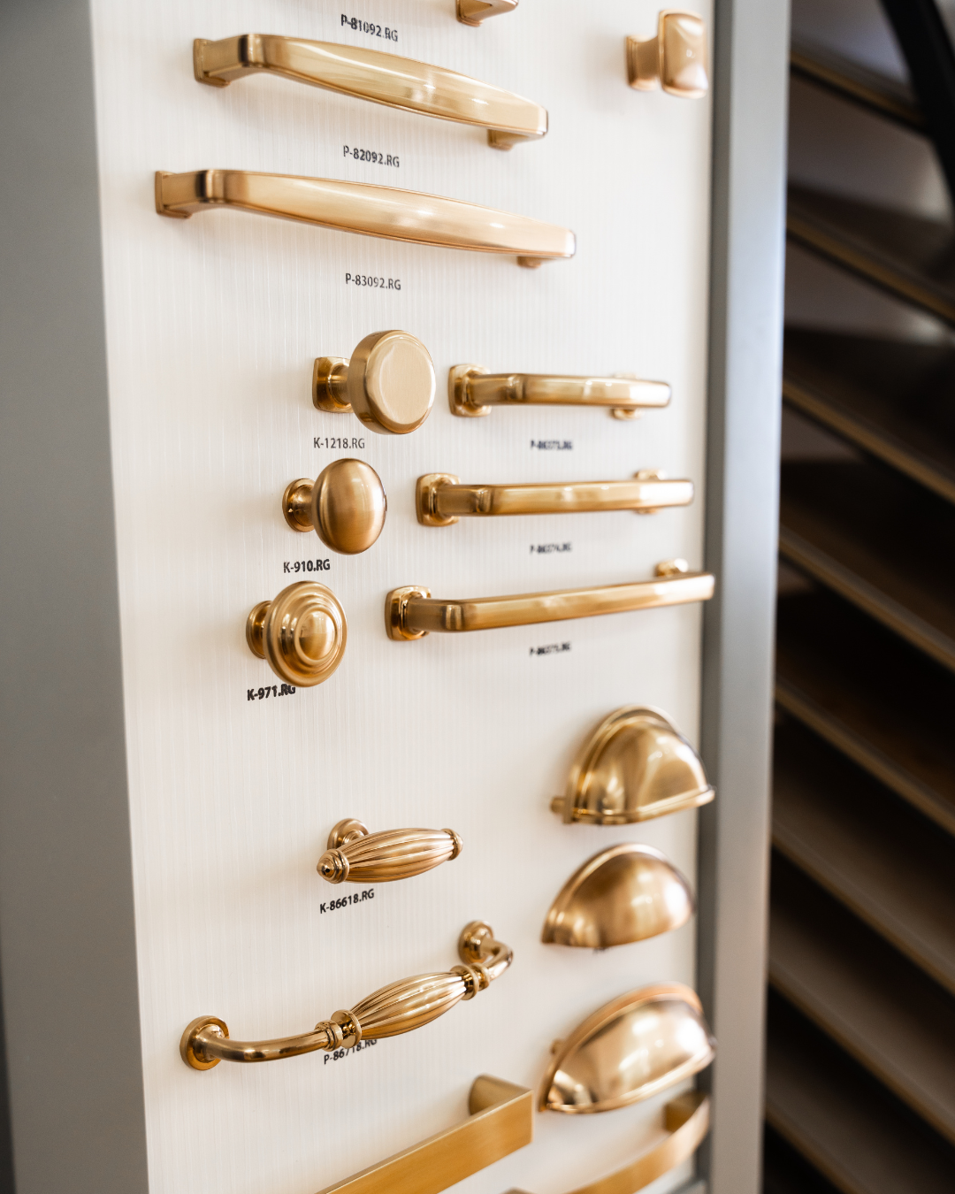 Wall display in The Designery showroom with several different types of drawer hardware, pulls, and knobs